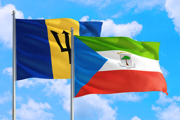 Equatorial Guinea and Barbados national flag waving in the windy deep blue sky. Diplomacy and international relations concept.
