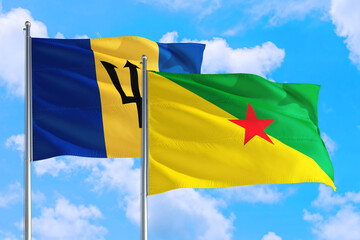 French Guiana and Barbados national flag waving in the windy deep blue sky. Diplomacy and international relations concept.