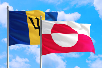 Greenland and Barbados national flag waving in the windy deep blue sky. Diplomacy and international relations concept.