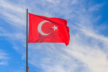 Waving flag of Turkey against blue sky