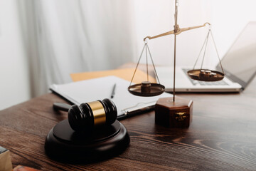 Business and lawyers discussing contract papers with brass scale on desk in office. Law, legal...