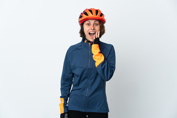 Young English cyclist woman isolated on white background with surprise and shocked facial expression