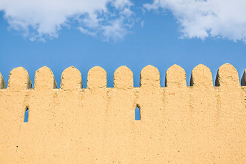 Clay fortress walls in Turkestan against the sky