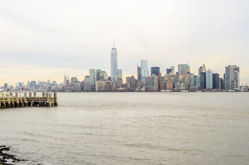 Fototapeta premium Manhattan Cityscape. Futuristic Buildings, Skyscrapers and Towers. The Largest Metropolitan Area in the World. Shot Taken from Ellis Island. New York City, USA