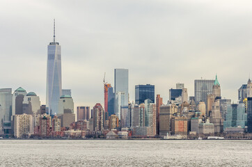 Obraz premium Manhattan Cityscape. Futuristic Buildings, Skyscrapers and Towers. The Largest Metropolitan Area in the World. Shot Taken from Ellis Island. New York City, USA
