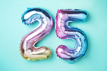 Rainbow foil balloon number, digit twenty-five. Birthday greeting card with inscription 25....