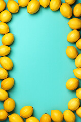 Lemons frame on blue background. Immune system booster. Copy space. Top view. Flat lay. Citrus fruits. Vitamins for health. Liposomal vitamin C. Lemon for vegan, vegetarian alkaline diet