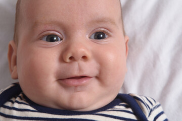 close up of a lying baby that smiles,