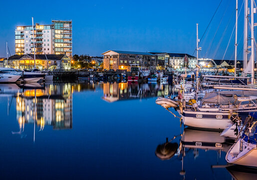 Yachts moored at the Plymouth Barbican Harbour at night