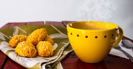 
cup of chocolate with yellow cup and breads