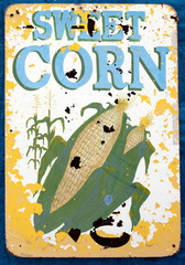 Weathered and faded SWEET CORN farm sign.