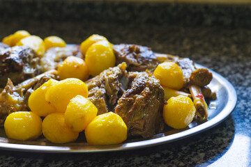 Tray of stewed meat with potatoes.