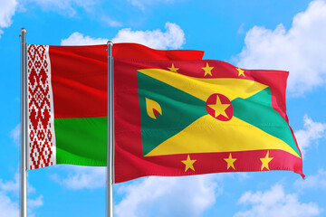 Grenada and Belarus national flag waving in the windy deep blue sky. Diplomacy and international relations concept.