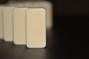 Domino on edge on black background