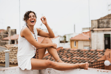 Naklejka premium Young woman in white blouse laughs out loud