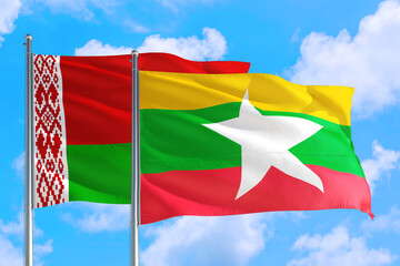 Myanmar and Belarus national flag waving in the windy deep blue sky. Diplomacy and international relations concept.