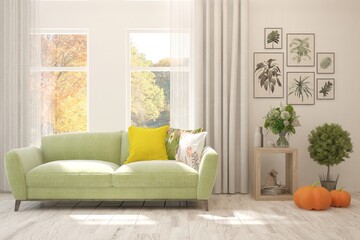 Stylish room in white color with sofa and autumn landscape in window. Scandinavian interior design. 3D illustration