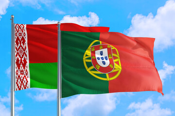 Portugal and Belarus national flag waving in the windy deep blue sky. Diplomacy and international relations concept.