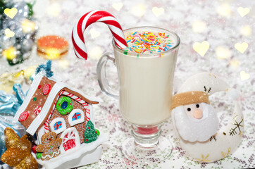 Milkshake with caramel cane, for winter holidays among Christmas decorations. Selective focus