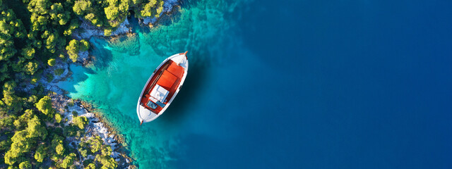 Aerial drone ultra wide panoramic photo of traditional wooden fishing boat anchored in Ionian...