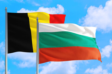 Bulgaria and Belgium national flag waving in the windy deep blue sky. Diplomacy and international relations concept.