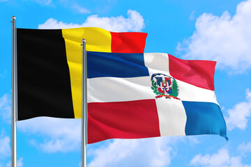 Dominican Republic and Belgium national flag waving in the windy deep blue sky. Diplomacy and international relations concept.