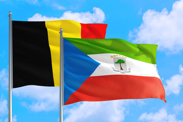 Equatorial Guinea and Belgium national flag waving in the windy deep blue sky. Diplomacy and international relations concept.