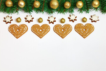 Bożonarodzeniowa dekoracja złożona z gałązek świerku i pierników na białym tle