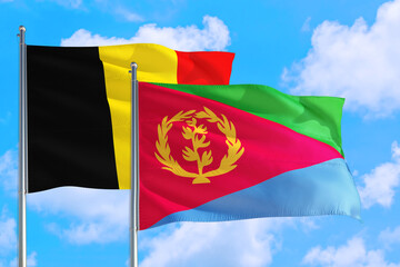 Eritrea and Belgium national flag waving in the windy deep blue sky. Diplomacy and international relations concept.