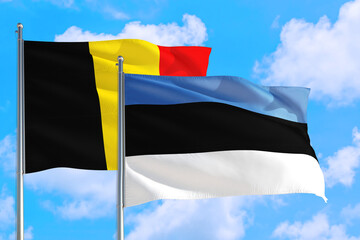 Estonia and Belgium national flag waving in the windy deep blue sky. Diplomacy and international relations concept.
