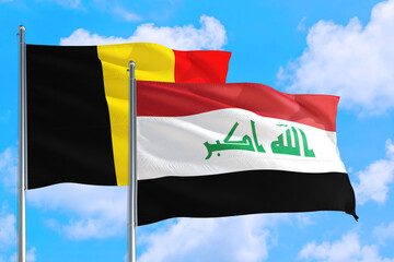 Iraq and Belgium national flag waving in the windy deep blue sky. Diplomacy and international relations concept.