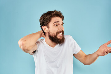 Emotional man with a beard in a white t-shirt blue background fun lifestyle