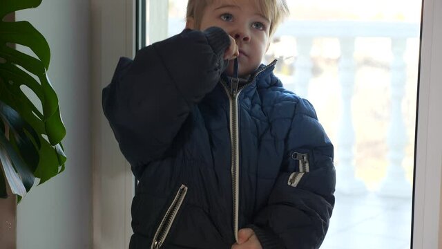 Cute Child Zipping his own Jacket. Little Boy Wearing Winter Attire. 2x Slow motion 60 fps 4K