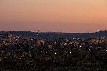 The city with lanterns in the mountainous area with a sunset or dawn sky