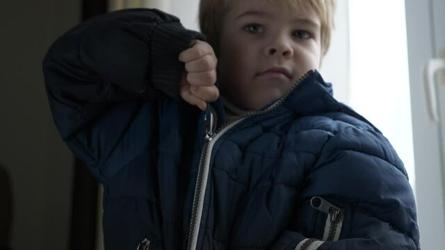 Cute Child Fastens Jacket with a Zipper. Little Boy Wearing Winter Attire Zipping with Zip-fastener. 2x Slow motion 60 fps 4K