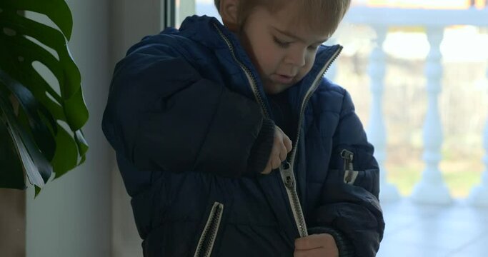Mother Helps Child Zipping his Jacket. Little Boy Wearing Winter Attire 4K