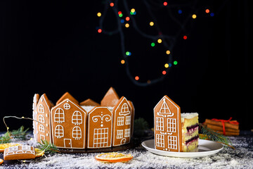Fototapeta premium Beautiful delicious cake with sprigs of rosemary and orange frips. New Year's dessert. Biscuit cakes, gingerbread.