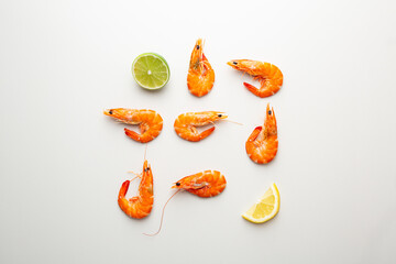 Overhead view of  Shrimps with lime on white surface