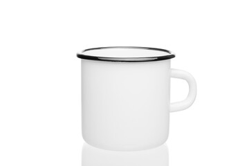 white metal mug with a black rim on a white background close-up, selective focus, reflection of the mug from below