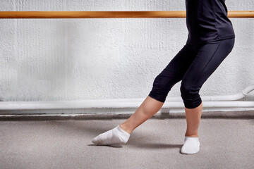 Feet a young man in white socks dancing in a ballet class. Ballet school. © Evgenia