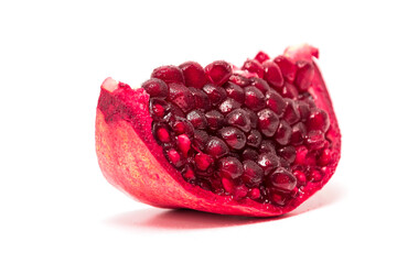 a slice of pomegranate on white background