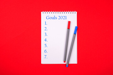 New Year Resolution Goal List 2021 - notebook written in handwriting about plan listing of new year goals and resolutions setting.