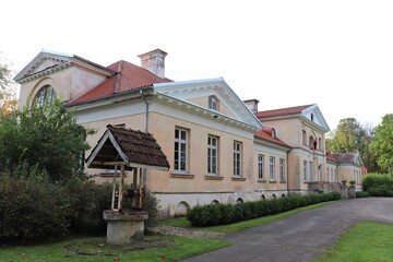 Well with a tiled roof is located next to Jaunauce Manor in Latvia in autumn 2020