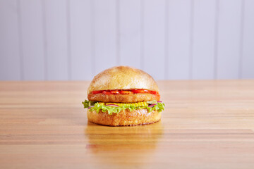 Chicken Burger special on wood in high key