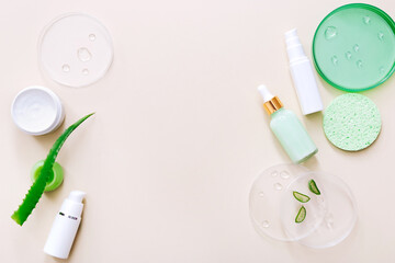 Natural herbal skin care products on light beige background. Aloe vera products. Top view