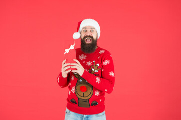 brutal hipster celebrate xmas party. winter holiday preparations. present and gift shopping sale. happy new year. merry christmas. cheerful bearded man in santa hat and sweater. Shopping Center