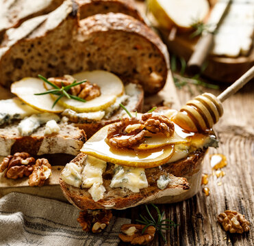 Sourdough Bread Sandwich With Gorgonzola Cheese, Walnuts And Honey Close Up View
