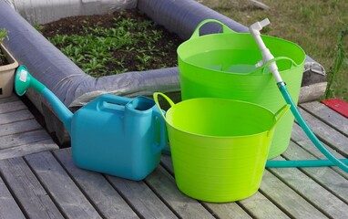 Bucket, watering can, these are all containers for watering.