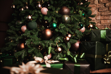 New Year's  gifts lie under the Christmas tree. Large gift boxes are yellow on the floor. Beautiful Christmas tree in  toys.