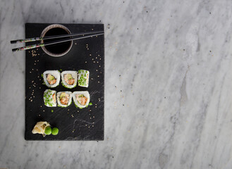 sushi on stone with chopsticks